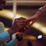 Engagement - man putting ring on woman's hand