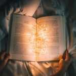 Story - person holding string lights on opened book