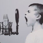 Voice - boy singing on microphone with pop filter