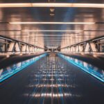 Visuals - a very long and empty walkway with blue lights