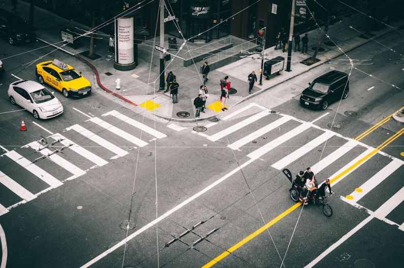 Visuals - people standing near pedestrian lane