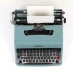 Copywriting - teal and black typewriter machine