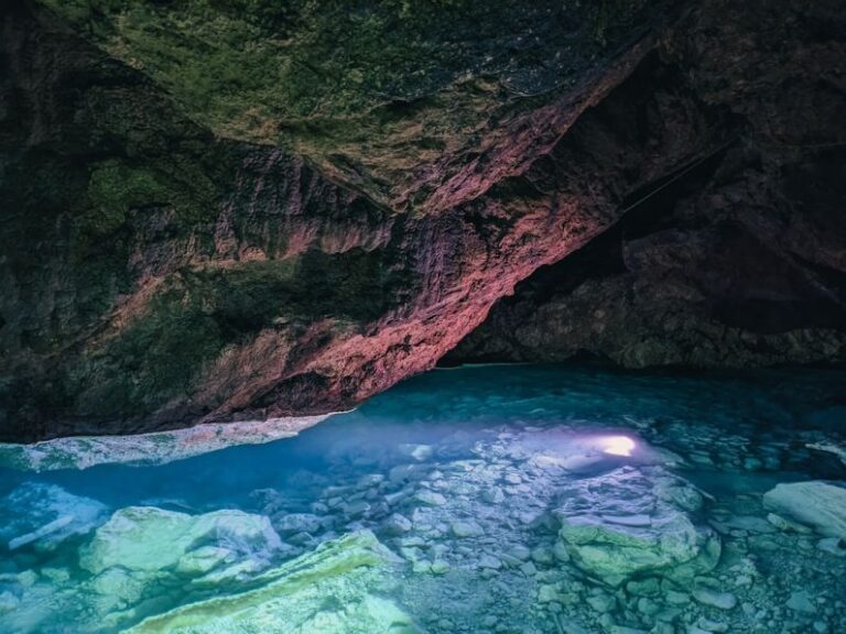 Pitfalls - a cave with a pool of water inside of it